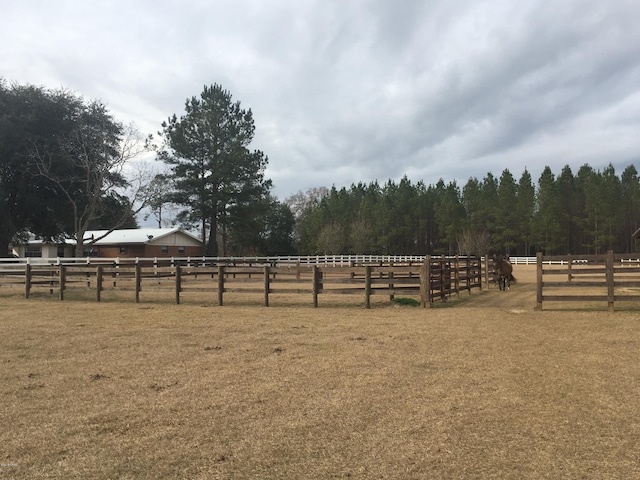 view of yard featuring an enclosed area and a rural view