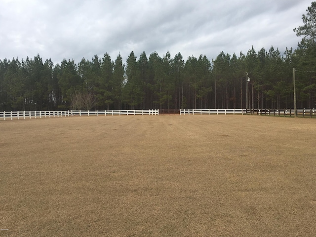 view of yard with a view of trees and fence