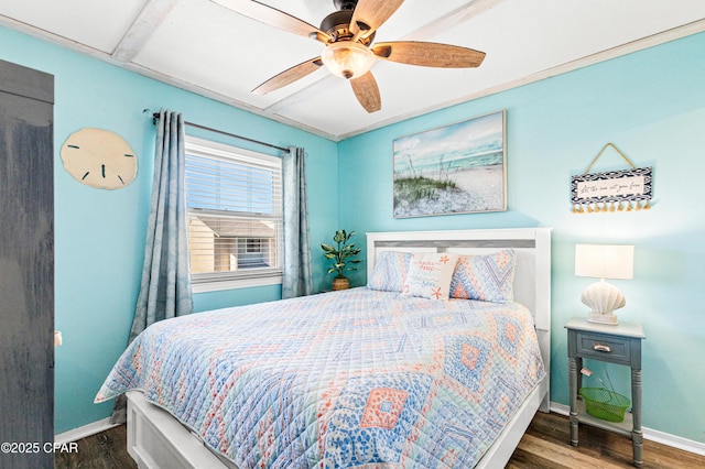 bedroom featuring a ceiling fan, baseboards, and wood finished floors