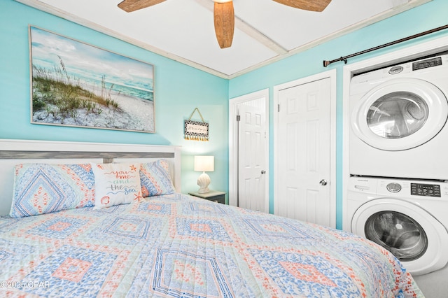 bedroom featuring stacked washer and dryer and a ceiling fan