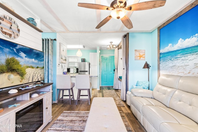 living area with ceiling fan and wood finished floors