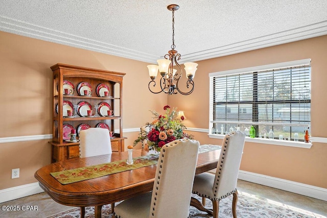 dining space featuring a textured ceiling, baseboards, and an inviting chandelier