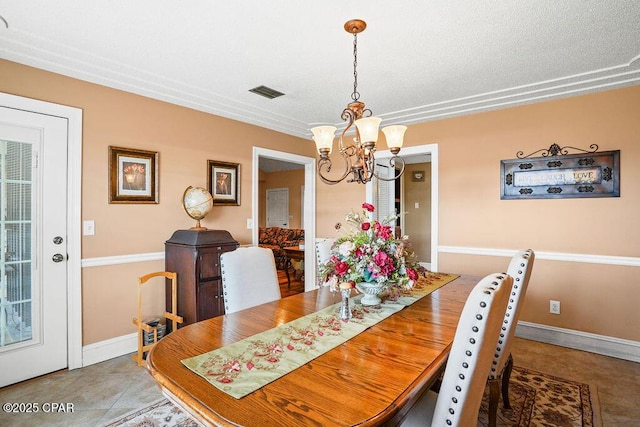 dining room with a chandelier, visible vents, baseboards, and tile patterned floors