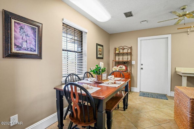 dining room with baseboards, visible vents, a ceiling fan, and light tile patterned flooring