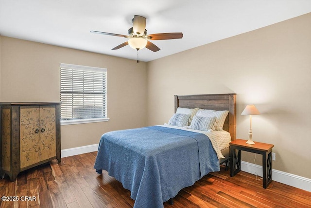 bedroom with a ceiling fan, baseboards, and wood finished floors