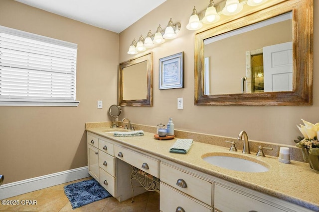 full bath with tile patterned flooring, a sink, baseboards, and double vanity