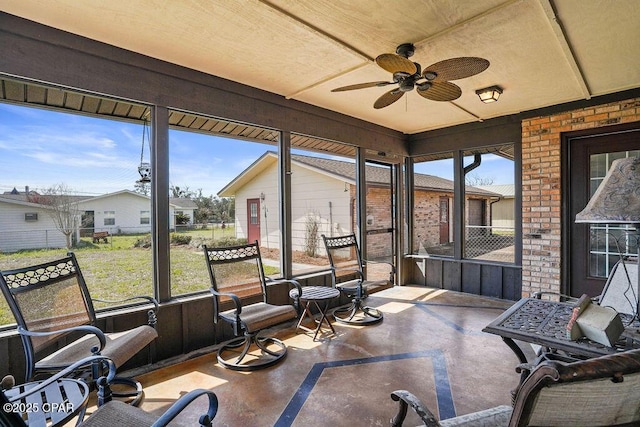 sunroom / solarium with ceiling fan and a healthy amount of sunlight