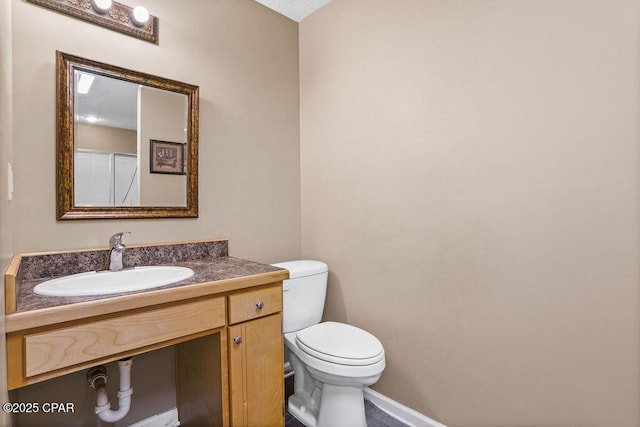 bathroom featuring a sink, toilet, and baseboards