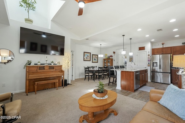 living area with baseboards, visible vents, a ceiling fan, lofted ceiling, and recessed lighting