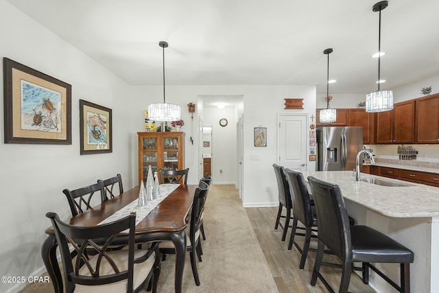 dining room with light wood-style flooring and baseboards