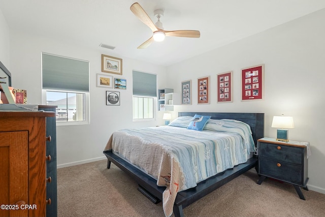 bedroom featuring a ceiling fan, baseboards, visible vents, and carpet flooring