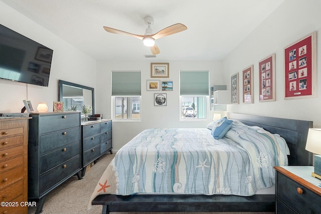 bedroom featuring carpet flooring, ceiling fan, and visible vents