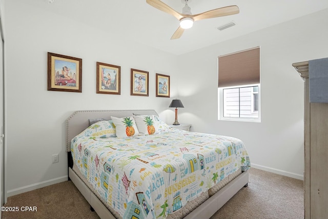 carpeted bedroom featuring ceiling fan, visible vents, and baseboards