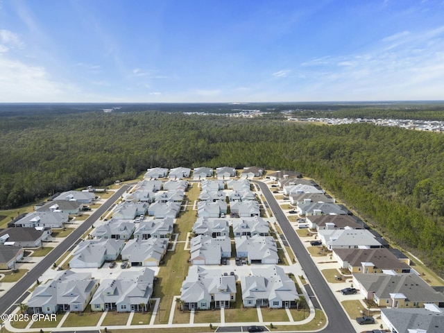 drone / aerial view with a residential view and a forest view