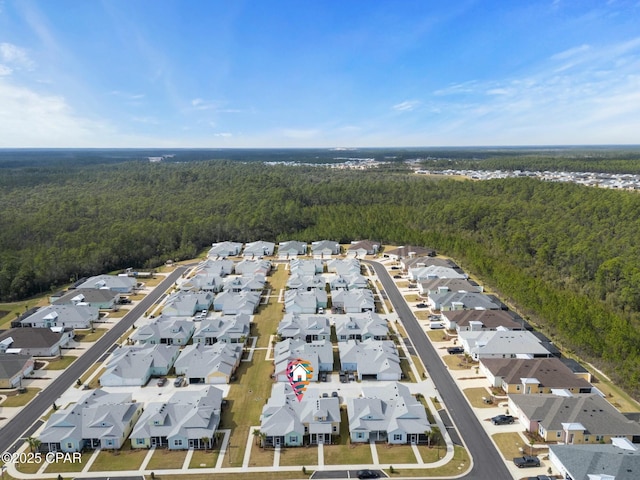 birds eye view of property with a residential view and a view of trees