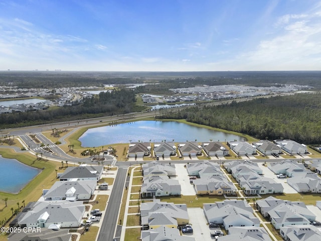 drone / aerial view featuring a residential view and a water view