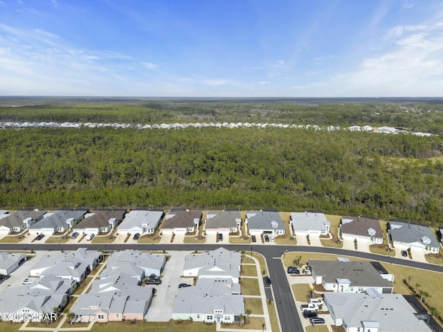 birds eye view of property featuring a residential view and a view of trees