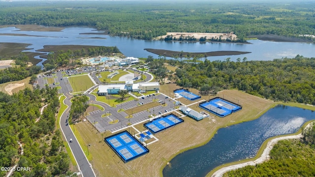 birds eye view of property with a water view and a wooded view