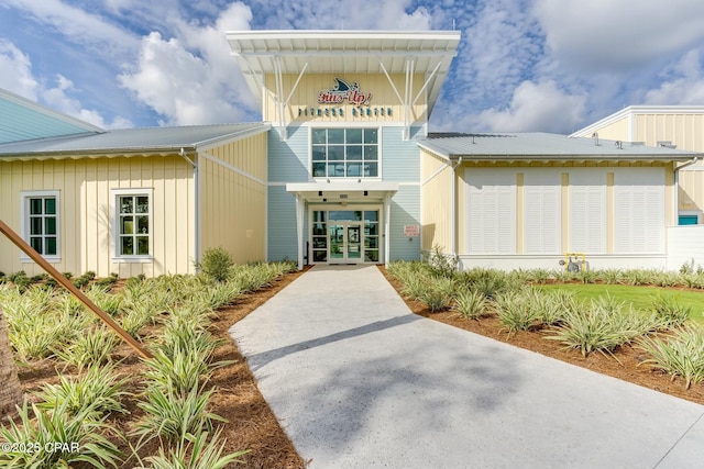 property entrance featuring french doors and metal roof