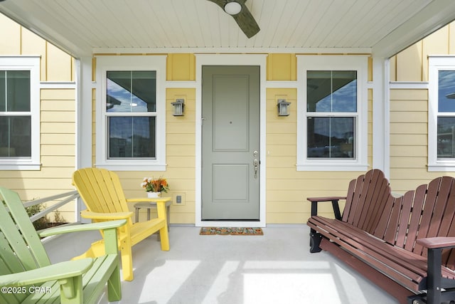 property entrance with ceiling fan and a porch