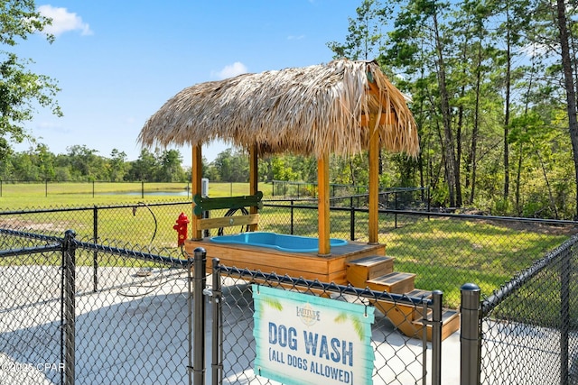 view of property's community featuring fence and a lawn