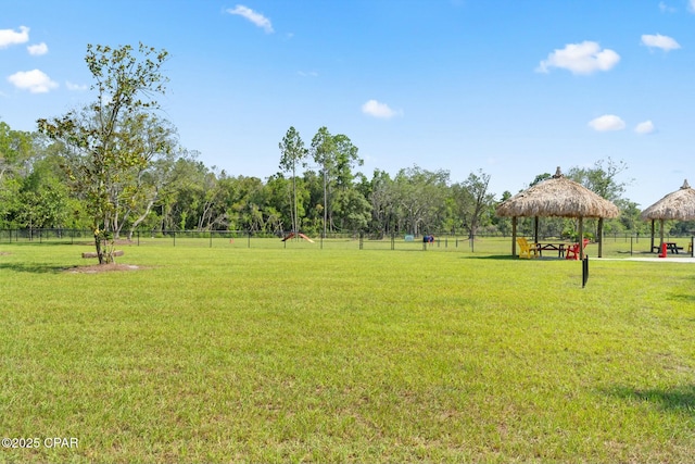 exterior space featuring a yard, fence, and a gazebo