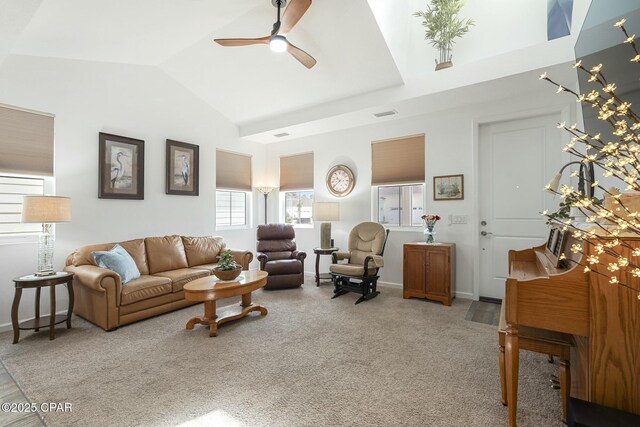 carpeted living area featuring visible vents, vaulted ceiling, baseboards, and ceiling fan