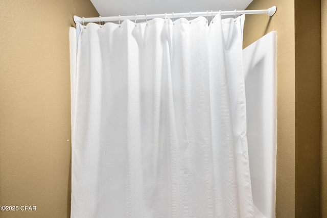 bathroom featuring curtained shower