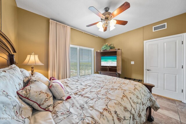 tiled bedroom with visible vents and ceiling fan