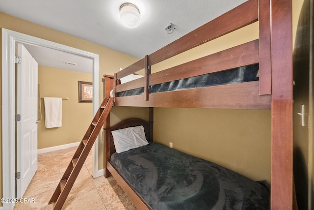 tiled bedroom featuring visible vents and baseboards