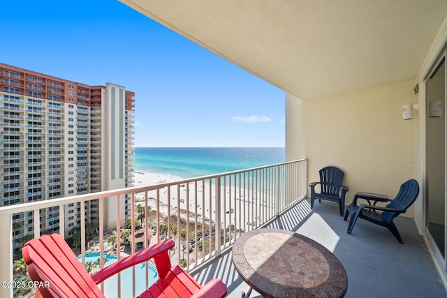 balcony featuring a water view and a view of the beach