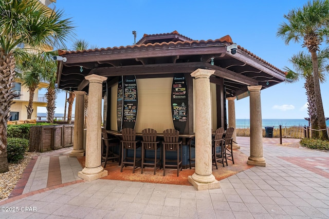 view of patio featuring fence and outdoor dry bar