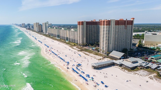 birds eye view of property featuring a view of city, a beach view, and a water view