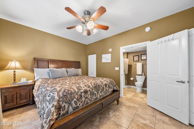 bedroom with light tile patterned flooring, ceiling fan, ensuite bathroom, and baseboards