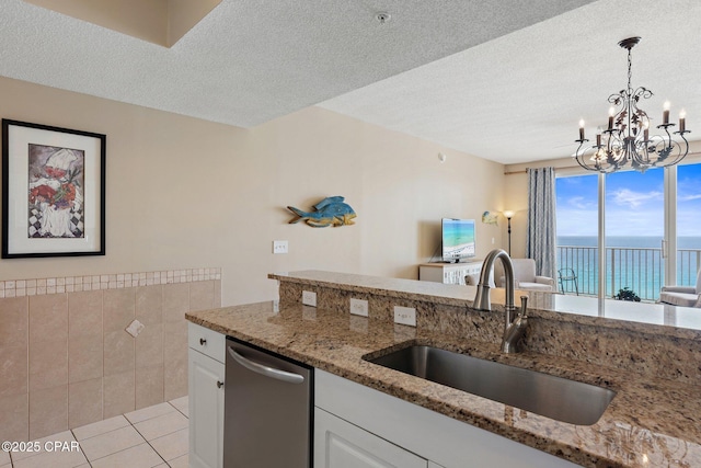 1160 Scenic Gulf Dr Unit A903, Miramar Beach, FL 32550 - kitchen featuring light stone countertops, an inviting chandelier, white cabinets, dishwasher, and a sink