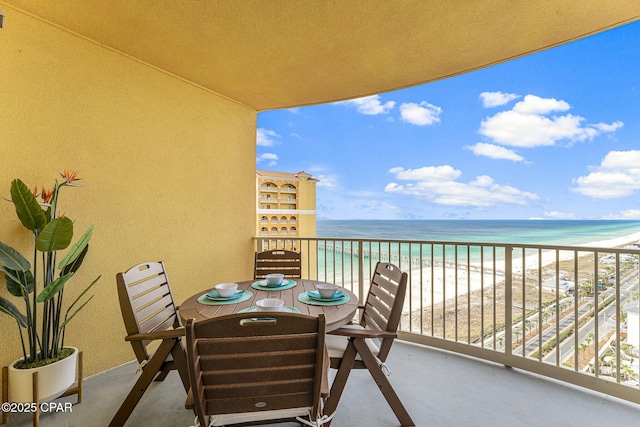 balcony featuring a water view and a view of the beach