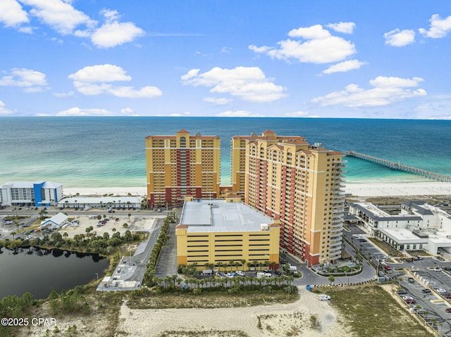 drone / aerial view featuring a water view and a view of the beach