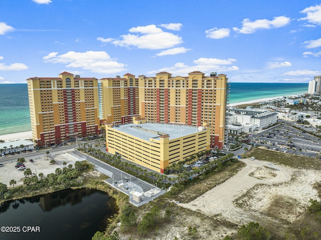 drone / aerial view with a beach view, a water view, and a city view