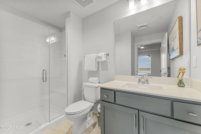 bathroom with a stall shower, visible vents, vanity, and toilet