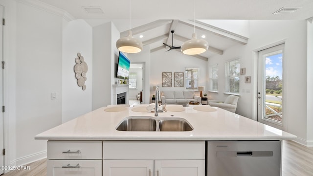 kitchen featuring a fireplace, visible vents, stainless steel dishwasher, open floor plan, and a sink