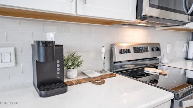 kitchen with white cabinetry, tasteful backsplash, appliances with stainless steel finishes, and light countertops