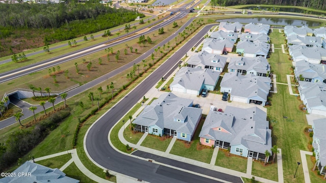 bird's eye view with a residential view and a water view