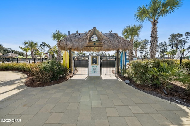 view of community featuring a gate, fence, and a gazebo