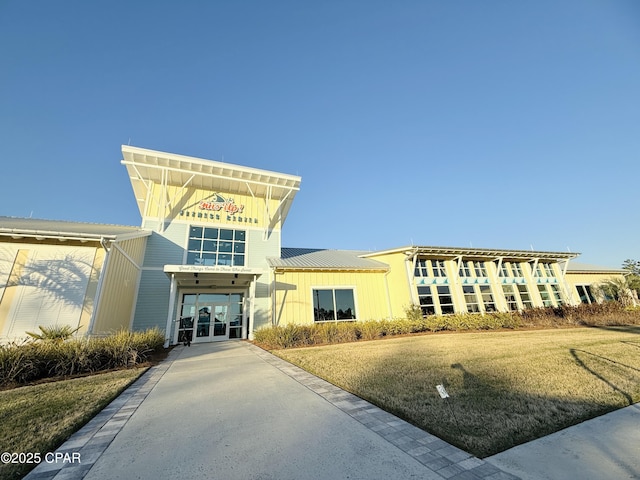 view of building exterior with concrete driveway and a carport