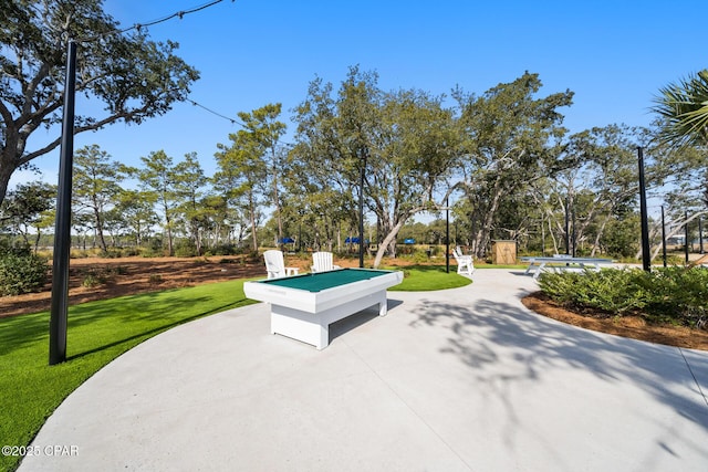 view of property's community with a yard and a patio