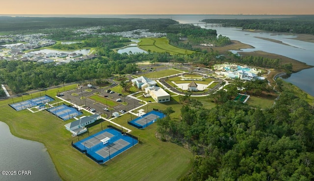 aerial view at dusk featuring a water view