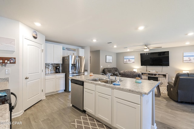 110 Spikes Cir, Southport, FL 32409 - kitchen with a sink, appliances with stainless steel finishes, open floor plan, light wood finished floors, and recessed lighting
