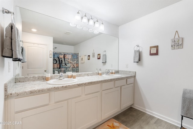 110 Spikes Cir, Southport, FL 32409 - full bath with double vanity, wood finished floors, and baseboards