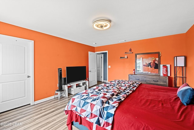 bedroom featuring wood finished floors and baseboards