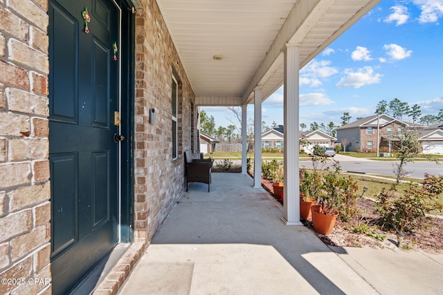 view of patio / terrace with covered porch and a residential view